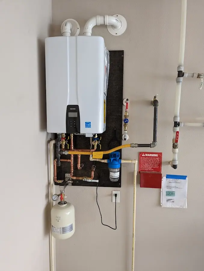 Professional plumber installing copper piping in a Sinton home